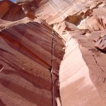 a climber on a sunny cliff in Utah