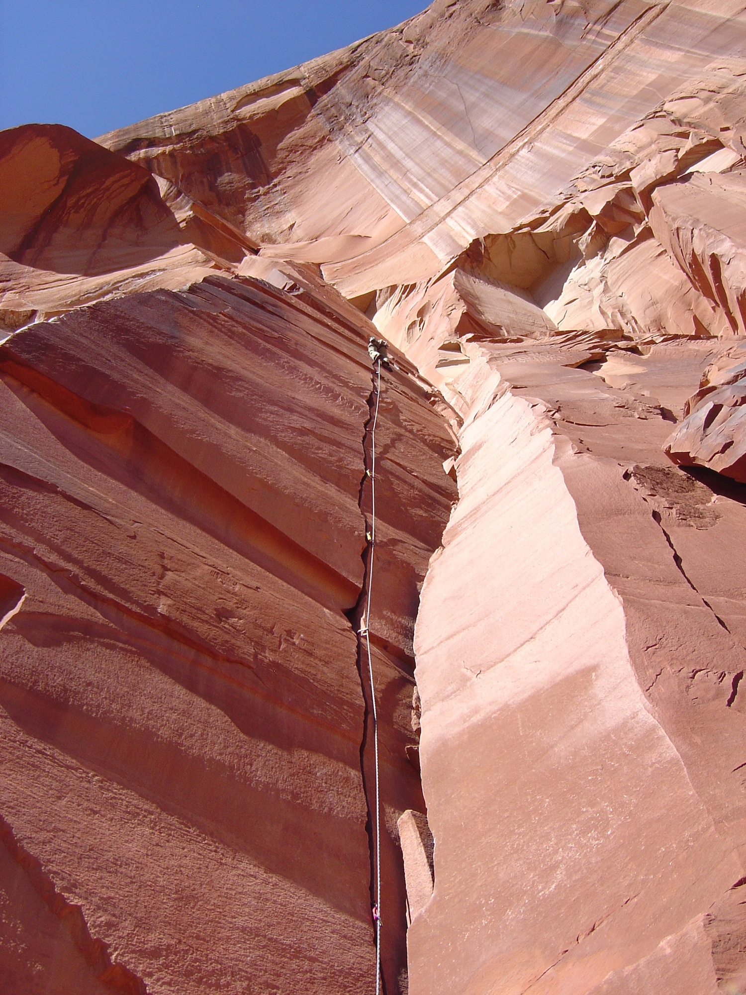 a climber on a sunny cliff in Utah