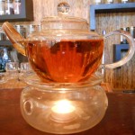 a glass pot of tea on a warmer