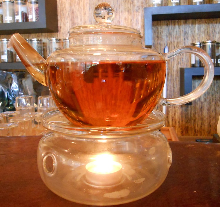 a glass pot of tea on a warmer